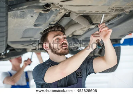 -means-your-safety-shot-of-a-two-professional-mechanics-checking-the-car-undercarriage-452825...webp