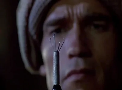 quaid-examines-the-tool-that-will-extract-the-homing-device-from-his-skull.webp