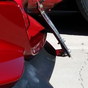 as you can see it is not touching the care. due to the strength of the steel it will not touch the body. its angled at a pleasing angle