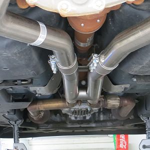 Final fit on vehicle.  You need a hand to have someone hold the muffler orientation at the back of the car while clamps are tightened.